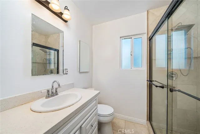 a bathroom with a shower a toilet and a sink