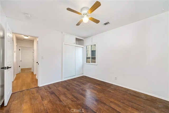 a bedroom with a bed dresser and a window