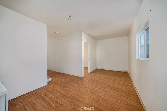 a view of a kitchen with wooden floor and a sink