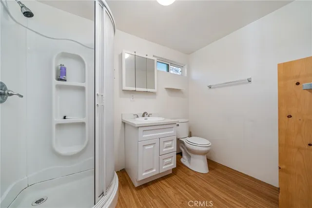 an empty room with a hardwood and ceiling fan