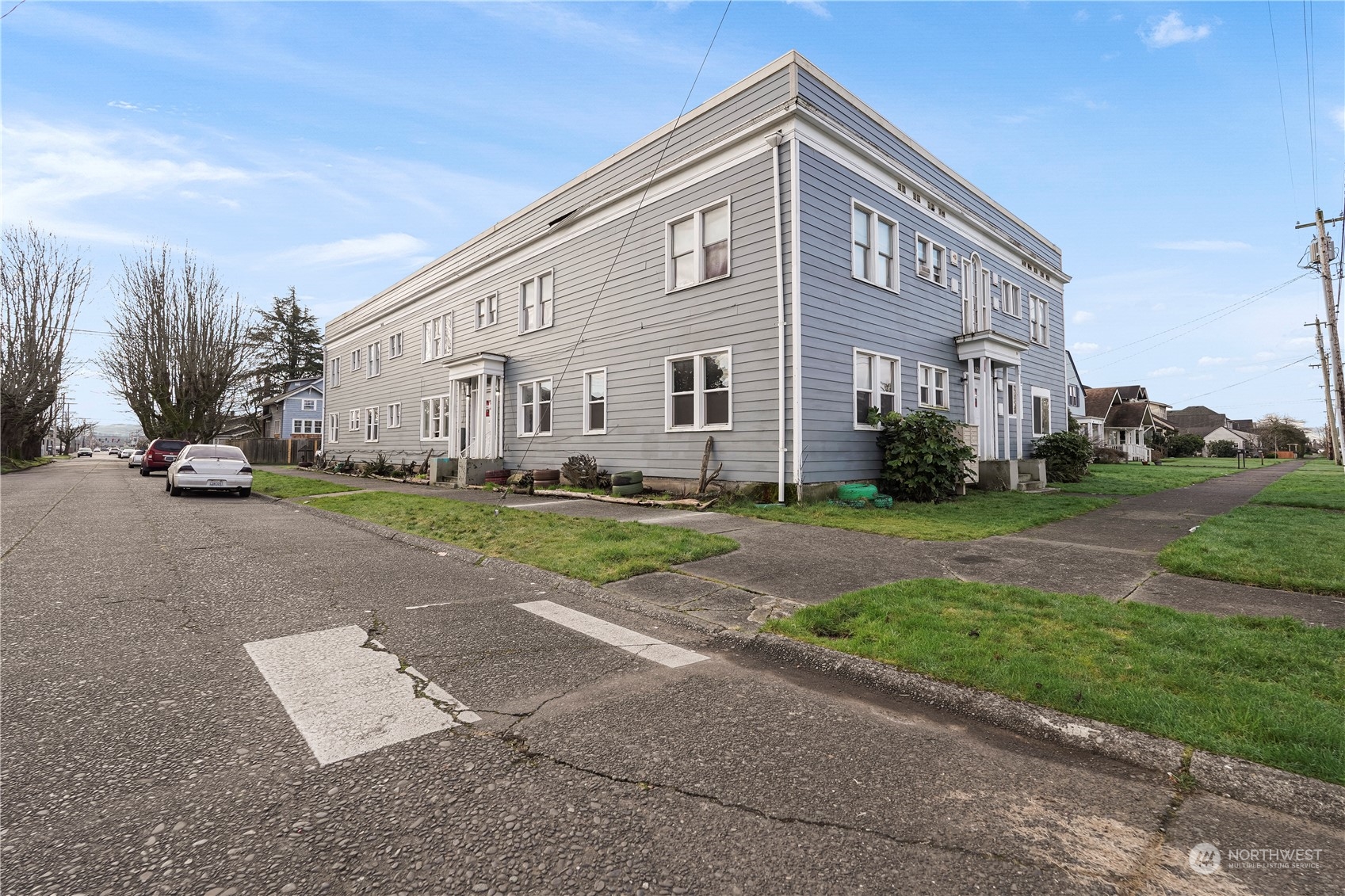 301 West 3rd Street Aberdeen, WA 98520 - Photo 4 of 15 a front view of a house with a yard and trees
