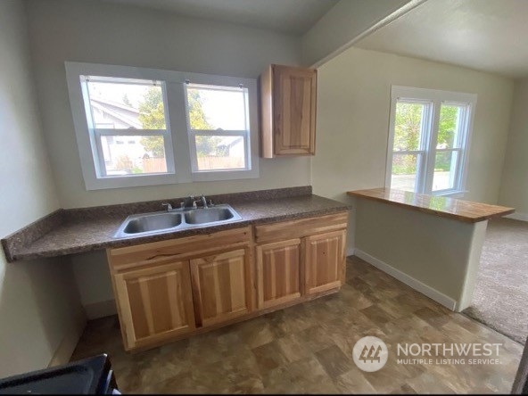 301 West 3rd Street Aberdeen, WA 98520 - Photo 9 of 15 a kitchen with granite countertop a sink and a stove