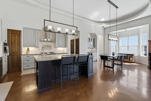 a view of a a dining room with furniture window and wooden floor