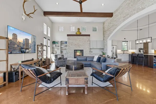 a living room with furniture a chandelier and a dining table