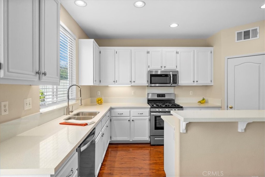 17557 Buttonwood Lane Carson, CA 90746 - Photo 8 of 43 a kitchen with a sink a stove and cabinets