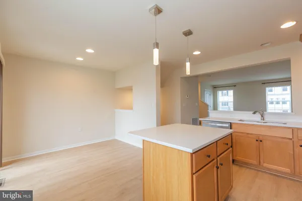 a kitchen with stainless steel appliances granite countertop a refrigerator a sink a stove a microwave and island