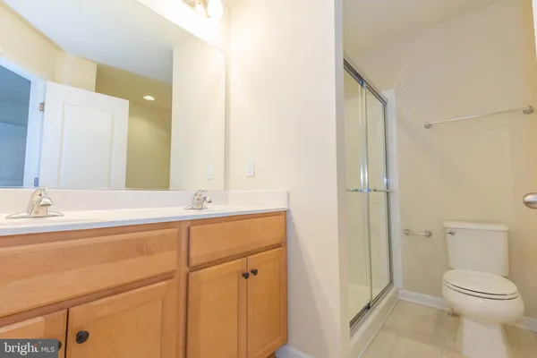 a white toilet sitting next to a bathroom sink
