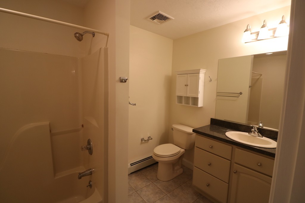 68 Brookfield Road, Unit 202 Charlton, MA 01507 - Photo 5 of 13 a bathroom with a sink a toilet and shower