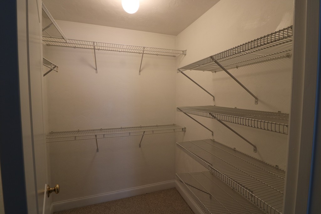 68 Brookfield Road, Unit 202 Charlton, MA 01507 - Photo 9 of 13 a view of a room with racks on the wall