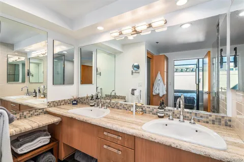 a bathroom with a double vanity sink mirror and double