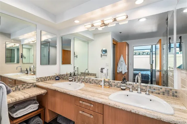 a bathroom with a double vanity sink mirror and double