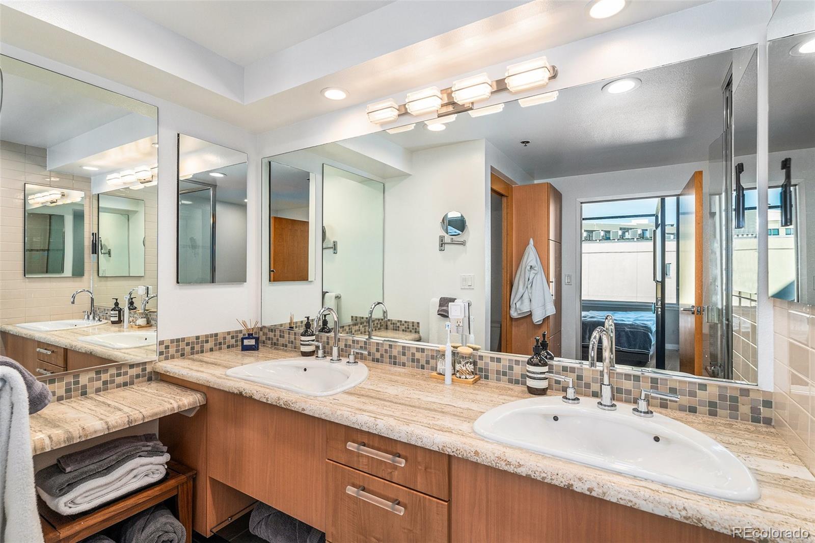 1401 Wewatta Street, Unit 911 Denver, CO 80202 - Photo 7 of 17 a bathroom with a double vanity sink mirror and double