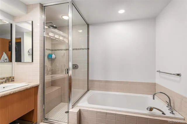 a bathroom with a bathtub and a shower