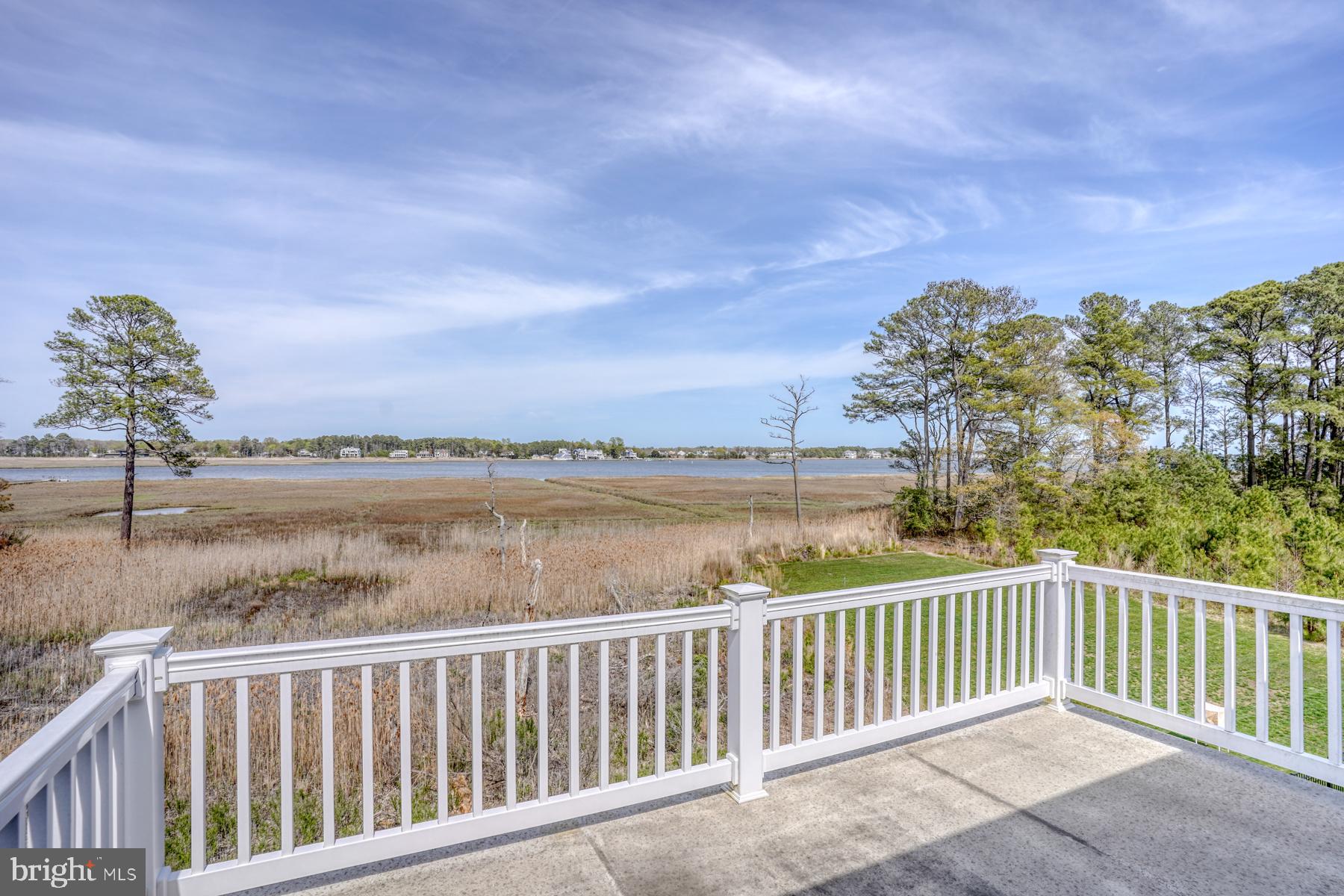 22253 Waterview Road, Unit 4 Lewes, DE 19958 - Photo 9 of 28 a balcony with wooden floor and lake view