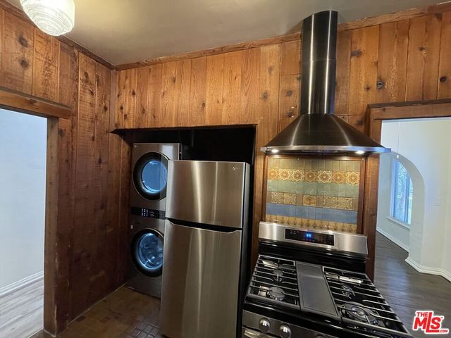 a kitchen with a refrigerator and a stove