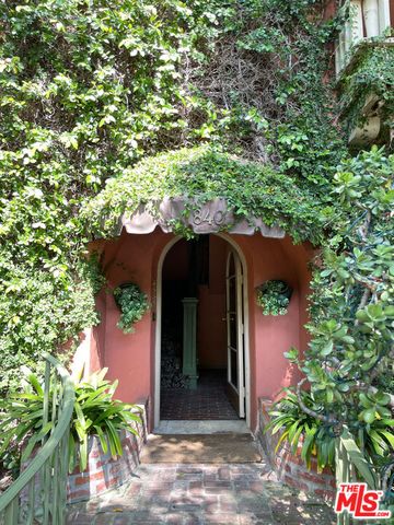 a view of a wooden door and a tree