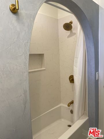 a bathroom with a tub and a shower