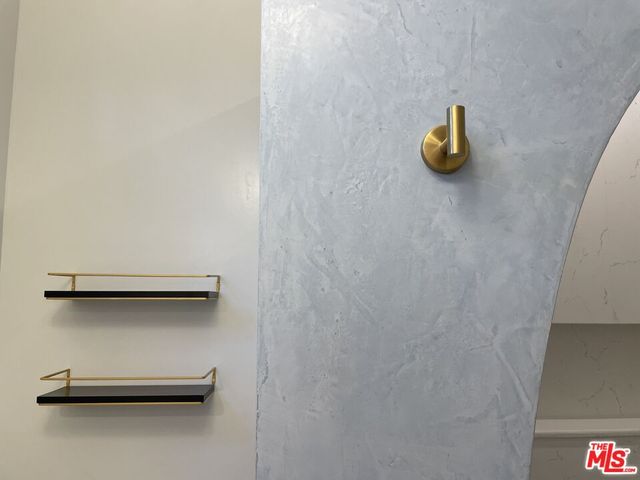 a view of a closet with a potted plant on th wall