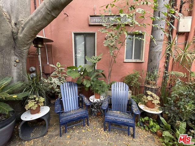 a view of a chair and table in backyard