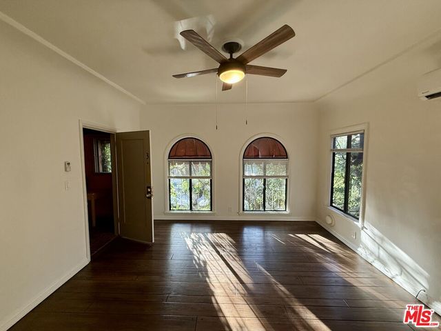 a view of room with window and wooden floor