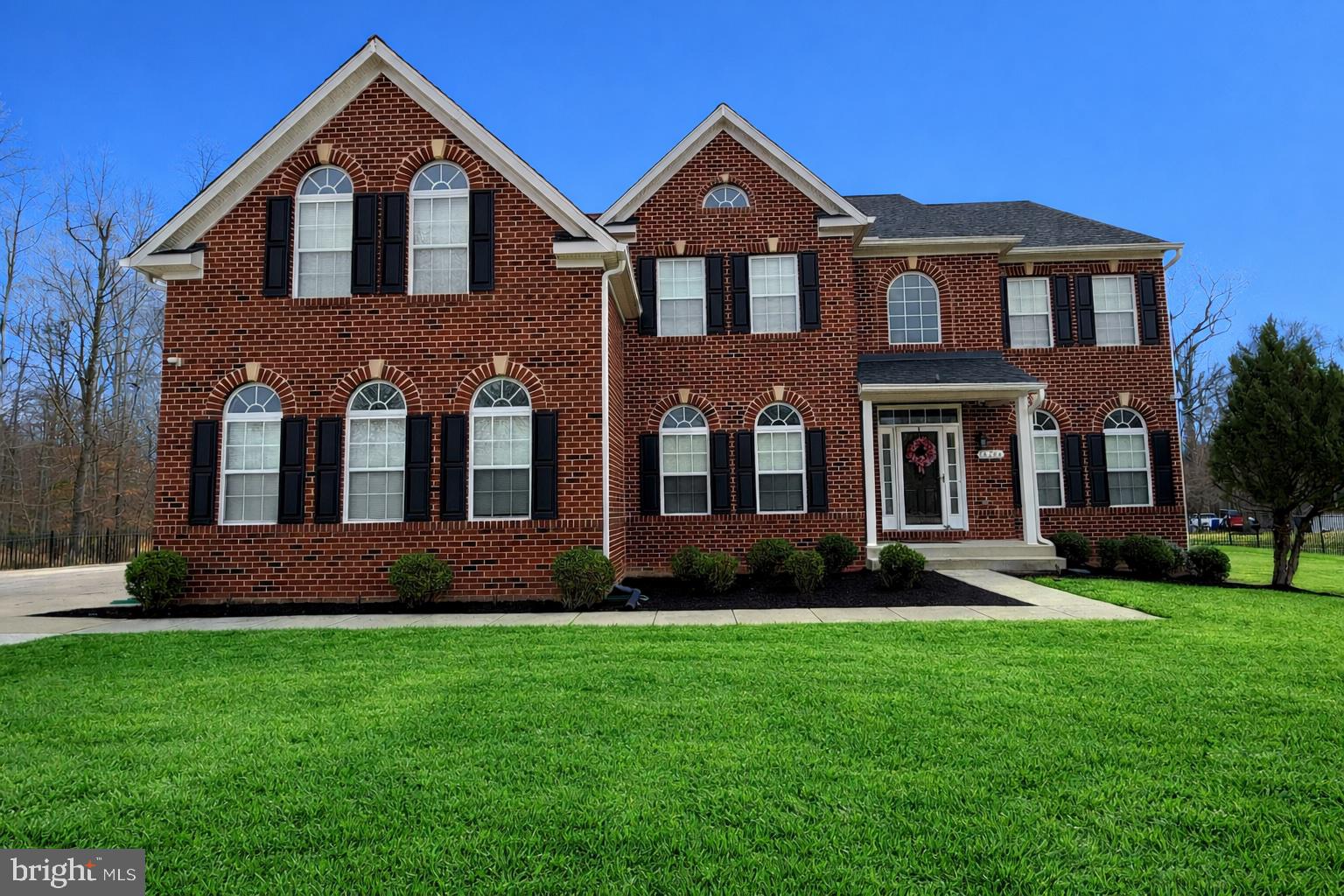 14204 Highlands Terrace Accokeek, MD 20607 - Photo 3 of 4 a front view of a house with a yard and green space