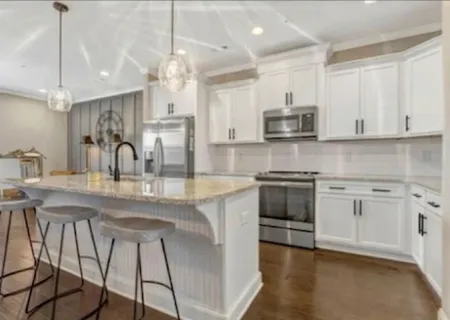 a kitchen with stainless steel appliances granite countertop a stove sink and cabinets