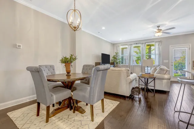 a view of a dining room with furniture a chandelier and wooden floor