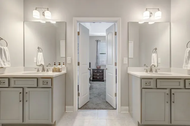 a en suite bathroom with a sink double vanity and a mirror