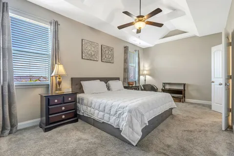 a bedroom with a bed and a chandelier