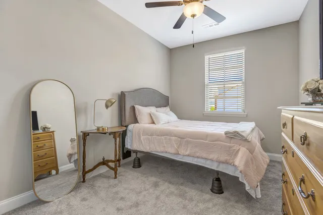 a bedroom with a bed a desk and chair