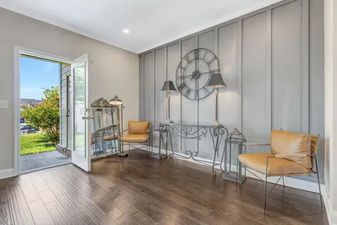a living room with furniture and a painting on the wall
