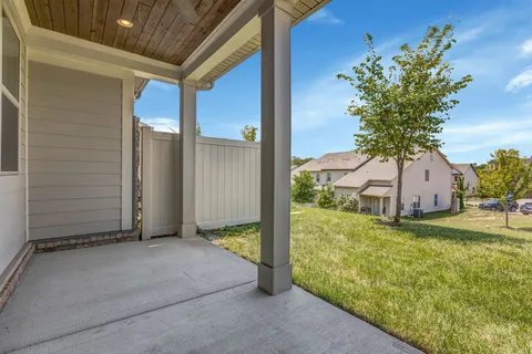 a view of a house with a tree and a yard