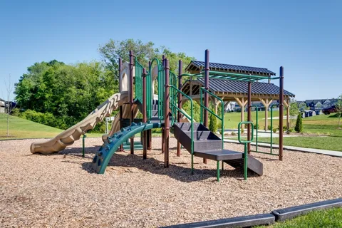 a view of patio with a table and chairs under an umbrella