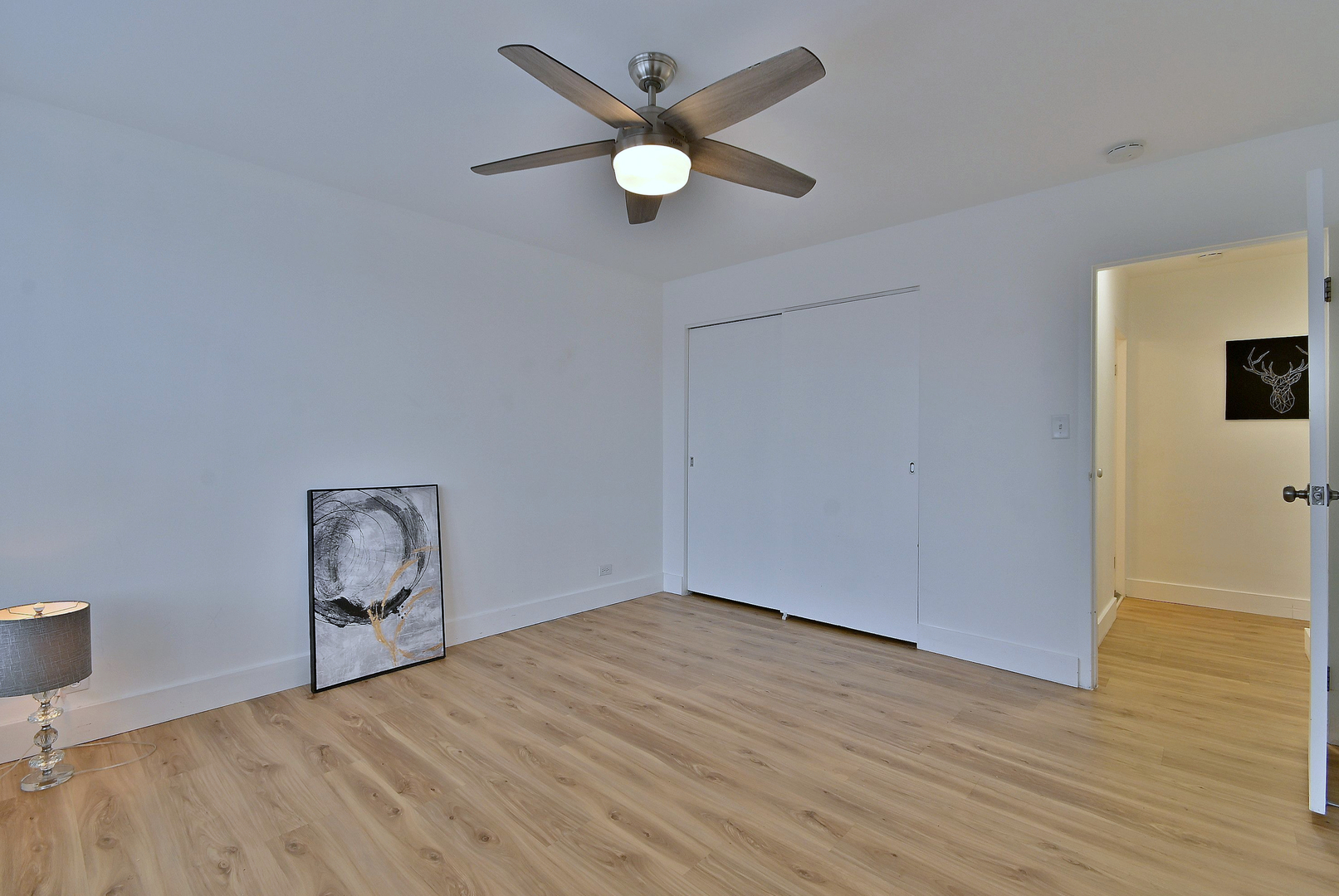 1301 West Touhy Avenue, Unit 315 Park Ridge, IL 60068 - Photo 13 of 17 an empty room with wooden floor and windows