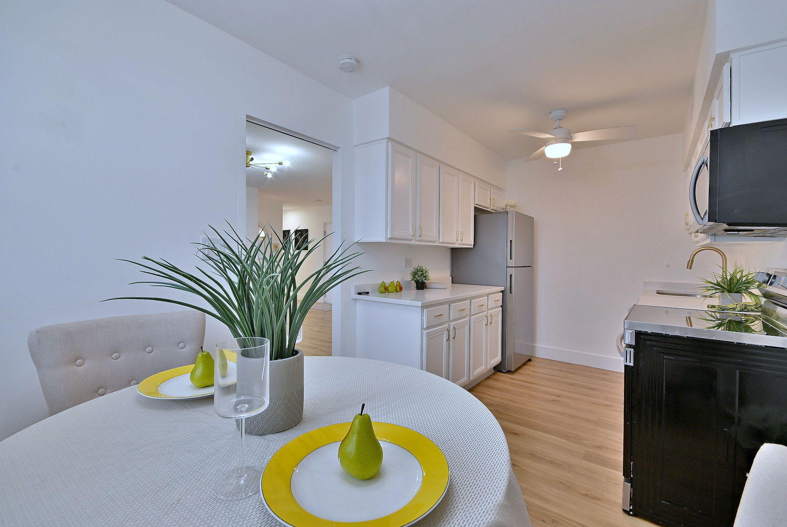 1301 West Touhy Avenue, Unit 315 Park Ridge, IL 60068 - Photo 7 of 17 a kitchen with a sink a faucet a stove and chairs