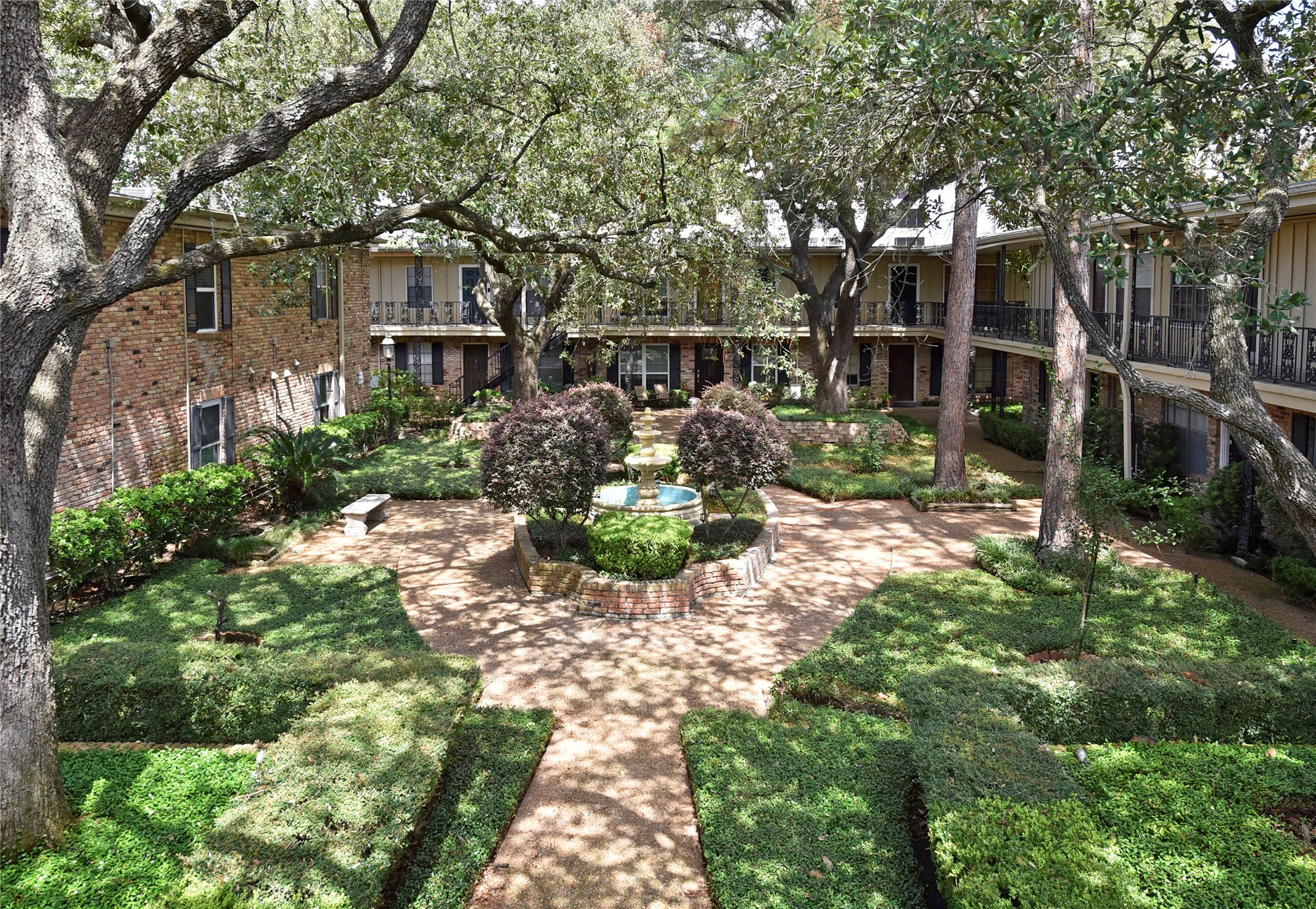 3224 Timmons Lane, Unit 112 Houston, TX 77027 - Photo 30 of 30 a front view of a house with a yard and outdoor seating