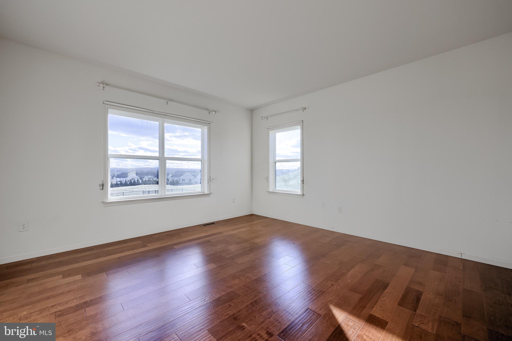 95 Hunters Chase Etters, PA 17319 - Photo 30 of 73 a view of an empty room with wooden floor and a window