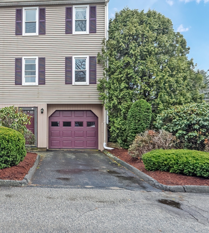 67 Providence Road, Unit 1 Grafton, MA 01519 - Photo 2 of 23 a front view of a house with a yard and garage