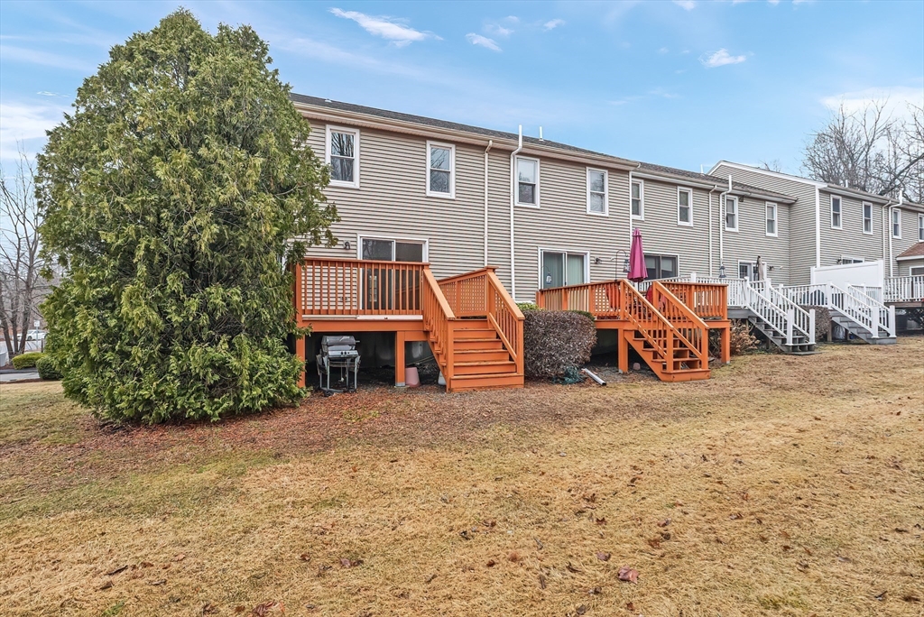 67 Providence Road, Unit 1 Grafton, MA 01519 - Photo 23 of 23 a view of a house with large trees