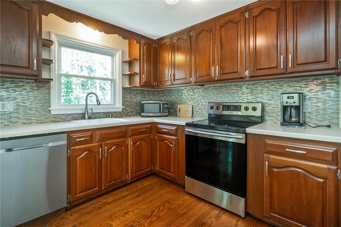 205 Bridle Path Road Bethlehem, PA 18017 - Photo 13 of 31 Rich wood cabinetry and classic countertops anchor this functional kitchen workspace.