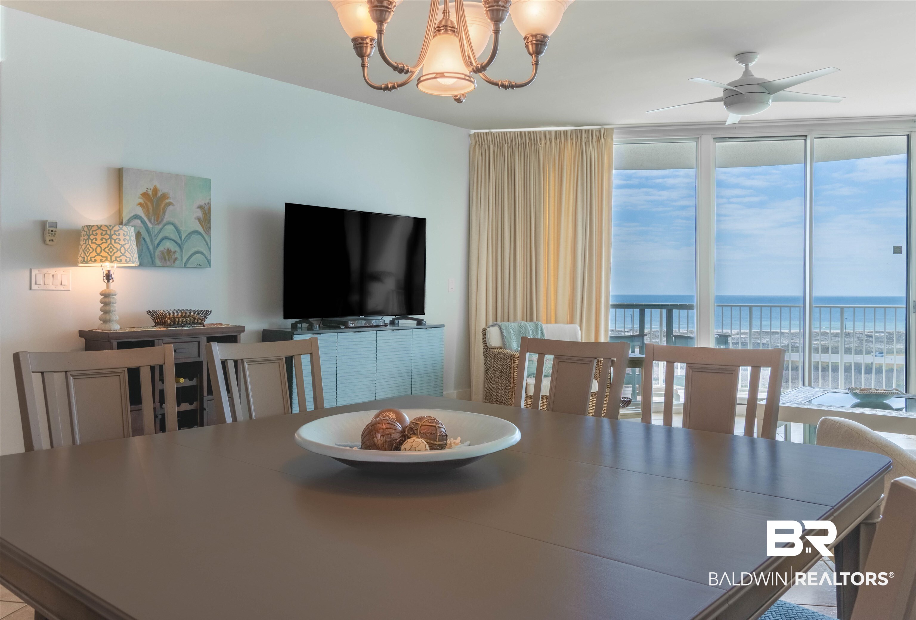 28107 Perdido Beach Boulevard, Unit D714 Orange Beach, AL 36561 - Photo 19 of 88 Dining room featuring ceiling fan with notable chandelier and expansive windows