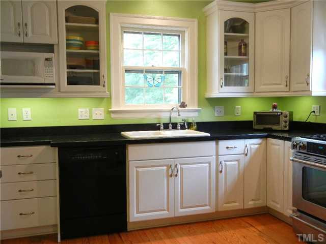 Kitchen is already remodeled! Under-cabinet lighting -- glass-front cabinets -- stainless gas stove (for you real chefs!) - hardwood floors -- plenty of storage (this is only 1 view--there's more cabinets)