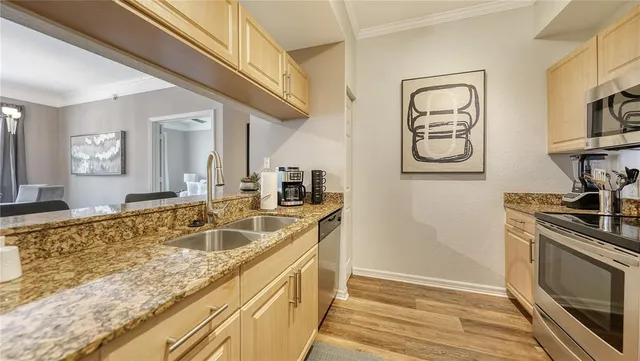 a kitchen with stainless steel appliances granite countertop a sink and cabinets