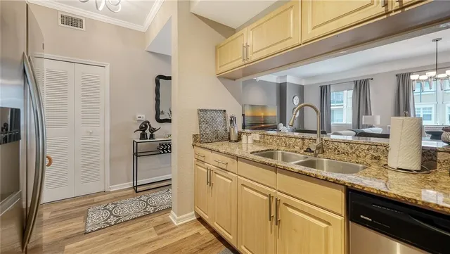 a view of a kitchen with a sink and refrigerator