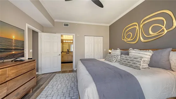 a bedroom with a bed and a television