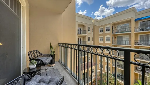 a view of a chairs and table in a balcony
