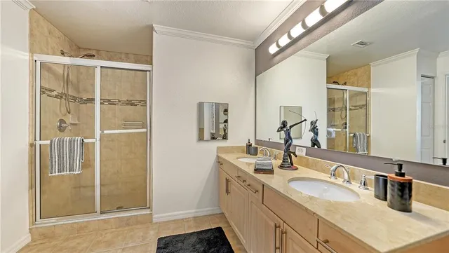 a bathroom with a double vanity sink a mirror and shower
