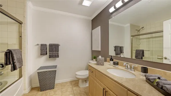 a bathroom with a double vanity sink toilet and mirror