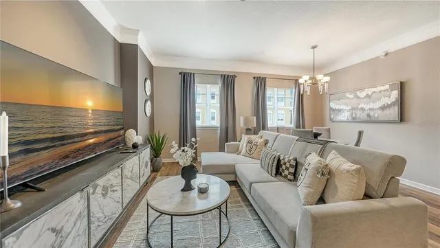 a living room with furniture and a chandelier