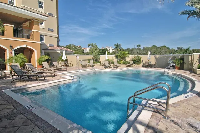 a view of a swimming pool with a lounge chairs